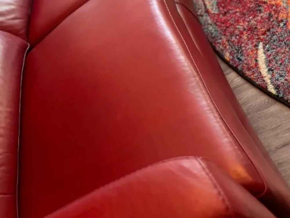 Close detail of a leather sofa cushion and seam